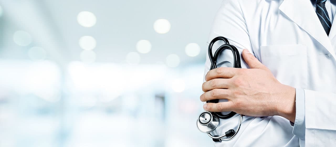 Imagem de um médico de braços cruzados com um estetoscópio